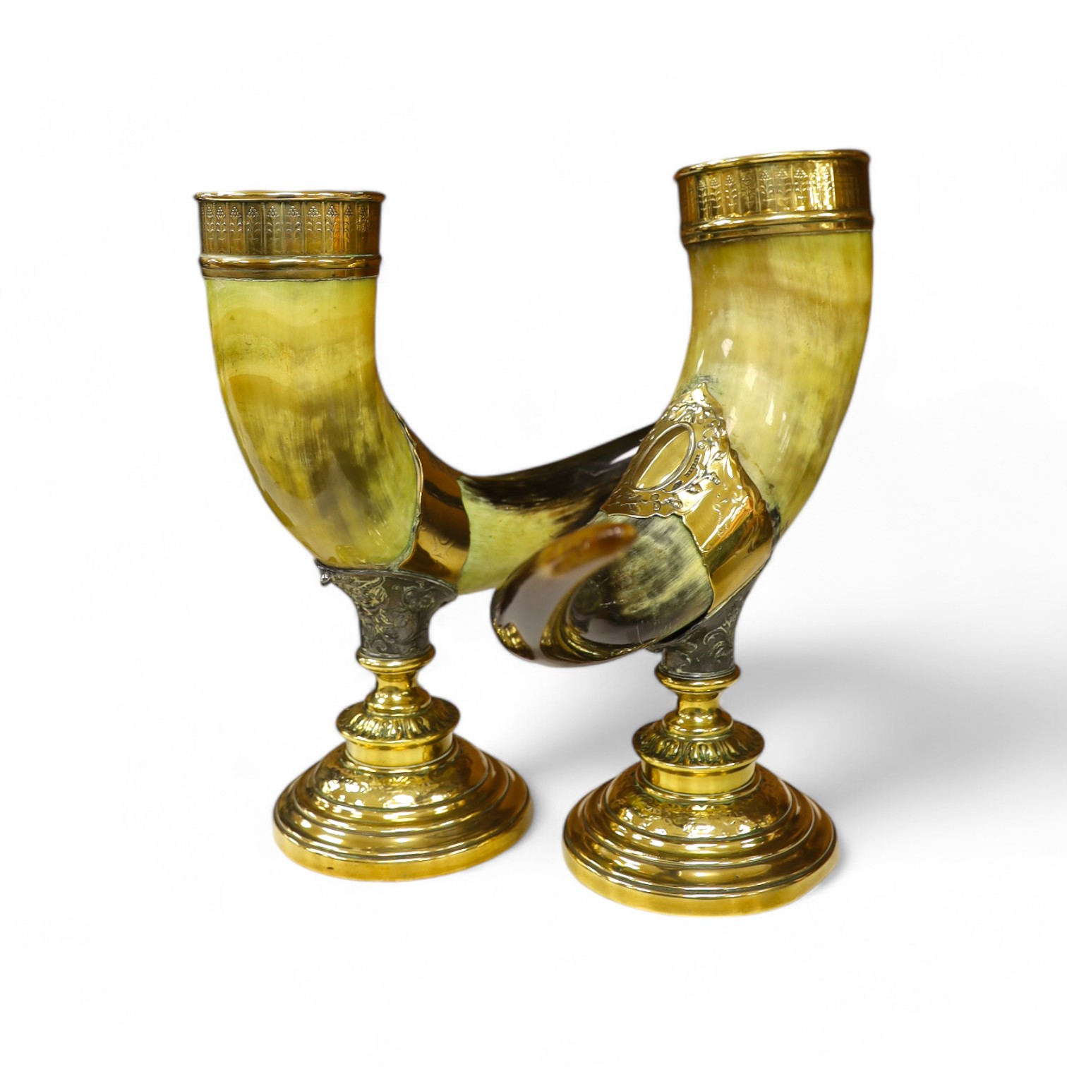 A pair of large decorative brass mounted horns, 33cm high. Condition - brass mounts dented and horns scratched in places